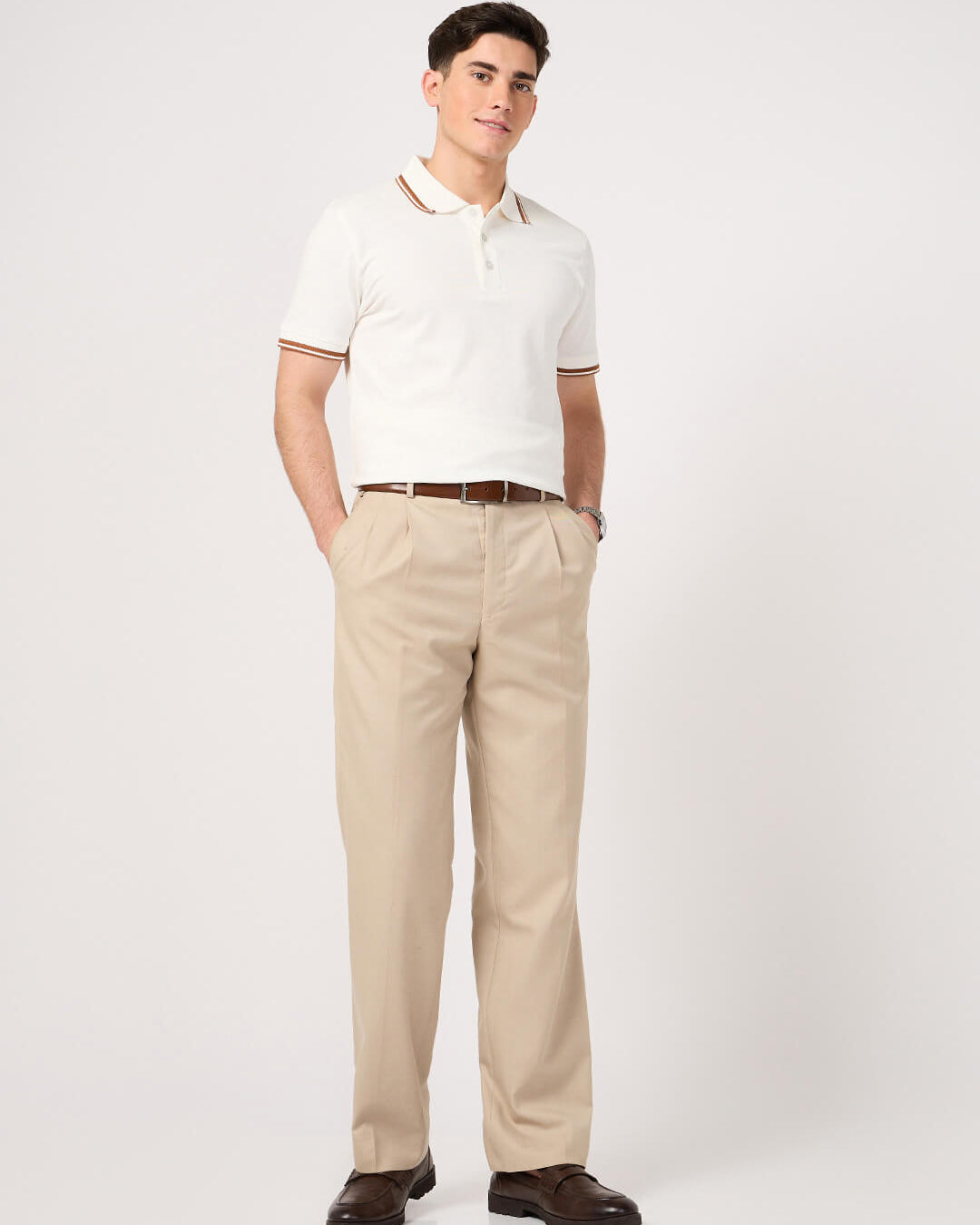man wearing a classic white polo t-shirt with jacquard collar and beige trouser