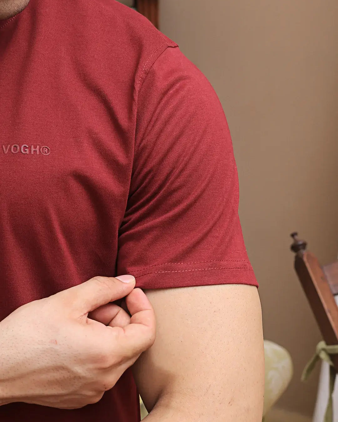Person wearing a red round neck t-shirt