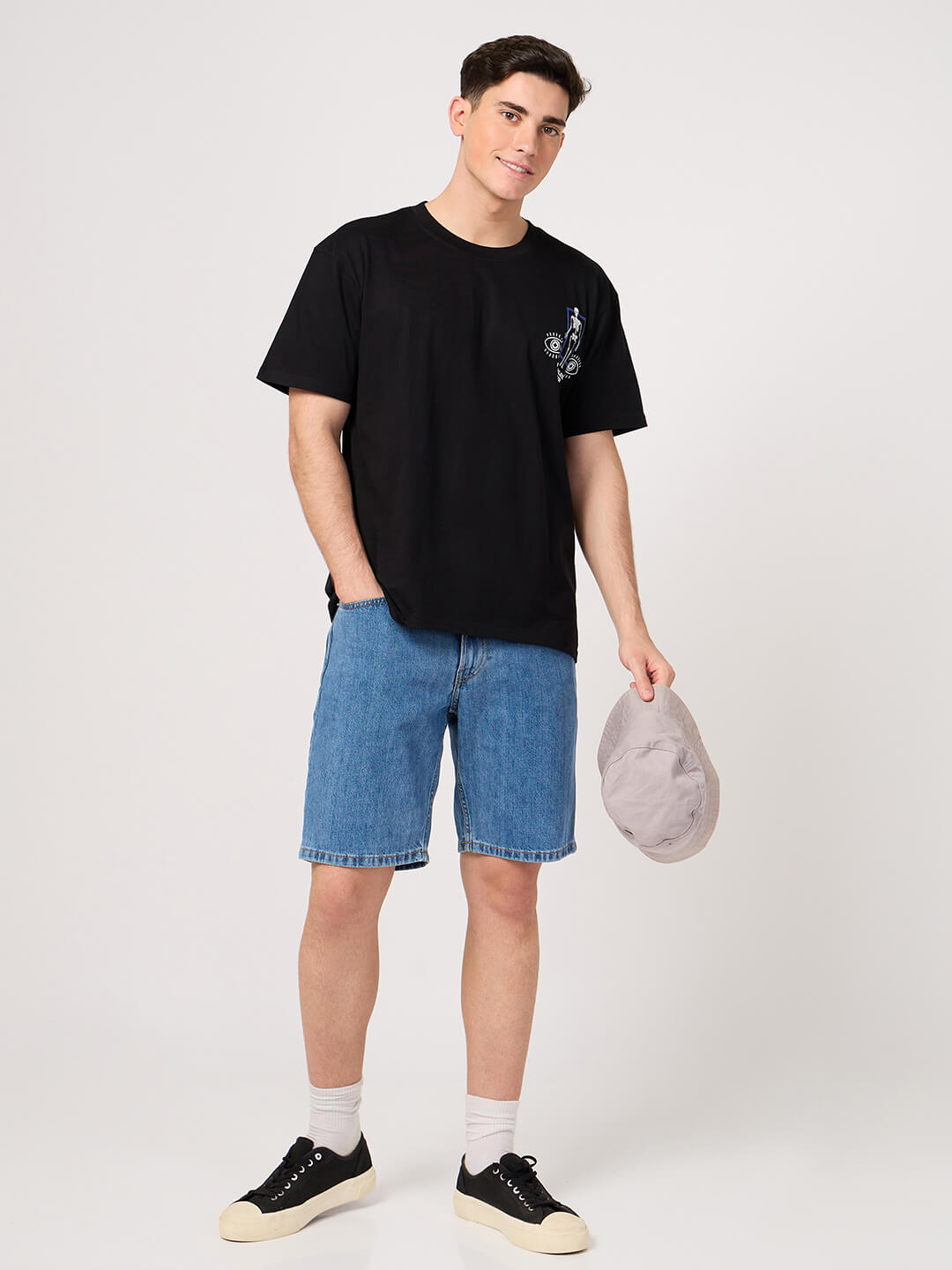 man wering a black printed t shirt with shorts