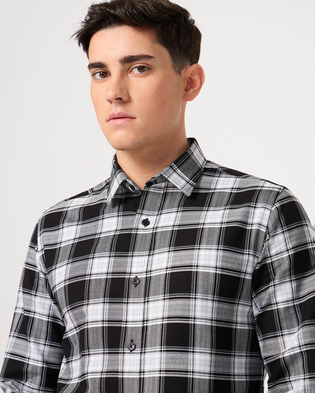 Man wearing a black and white plaid shirt made with pure cotton