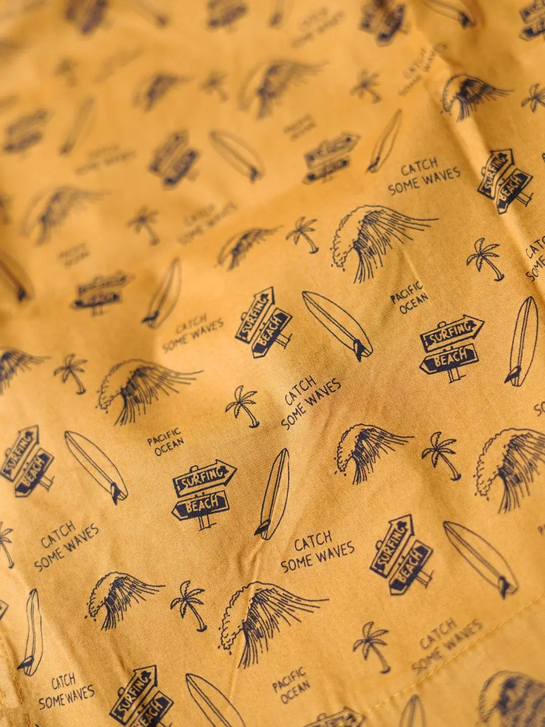 Patterned fabric with surfboard, palm tree