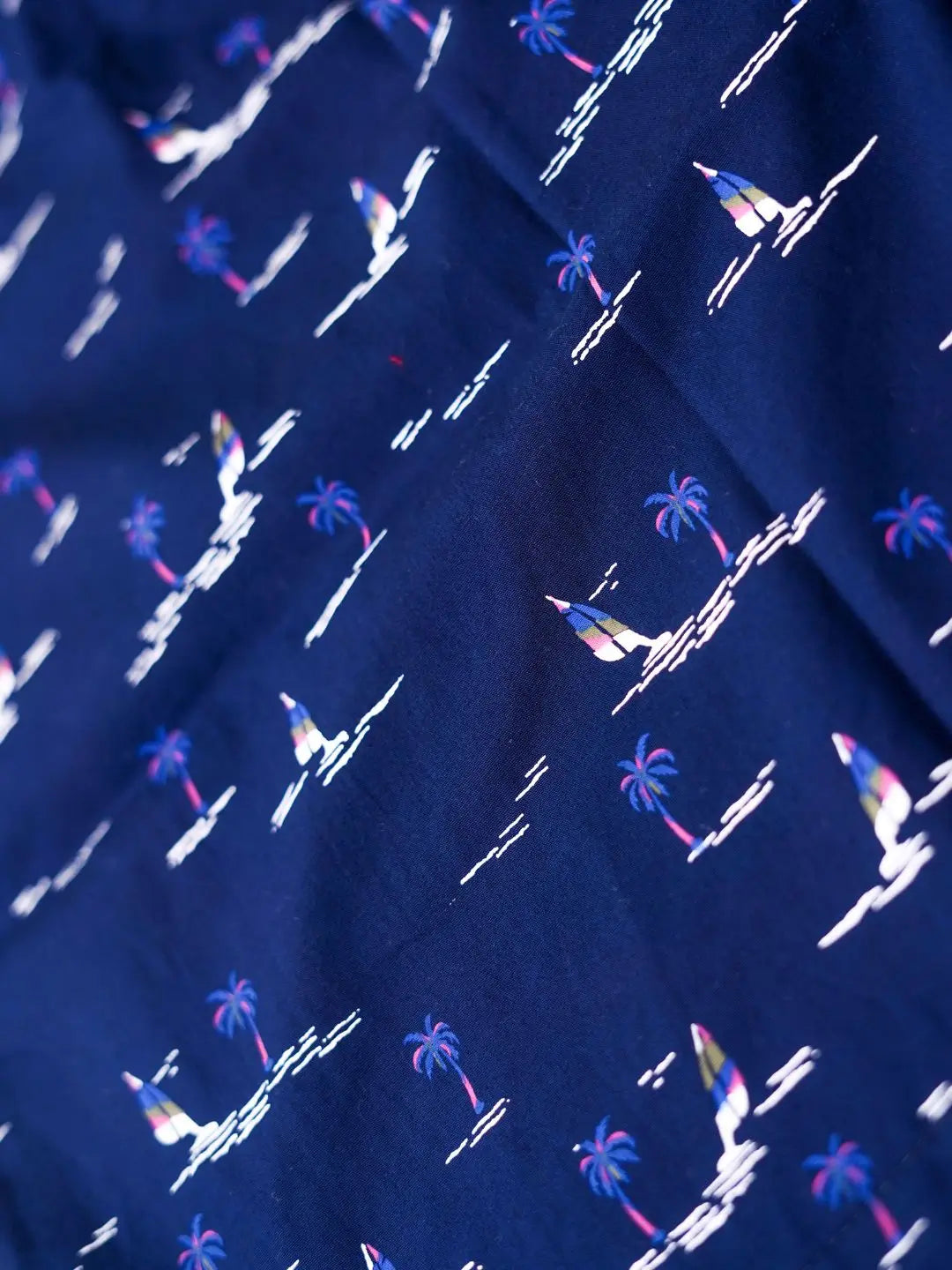 Navy blue boxer with white palm tree and sailboat