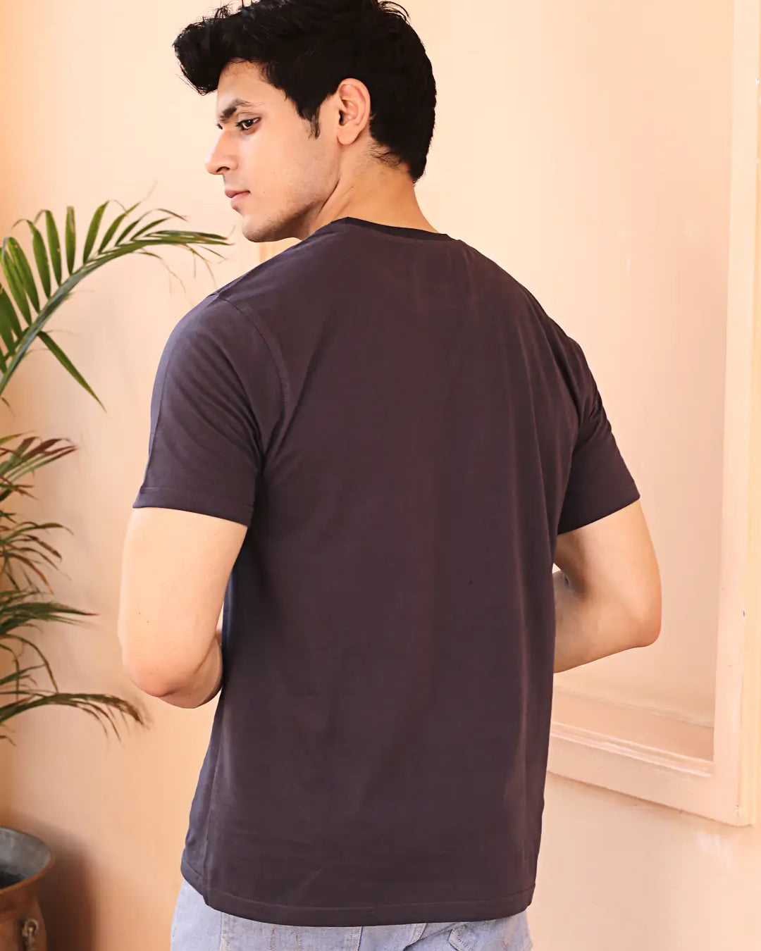 Man wearing a dark grey crew neck cotton t-shirt
