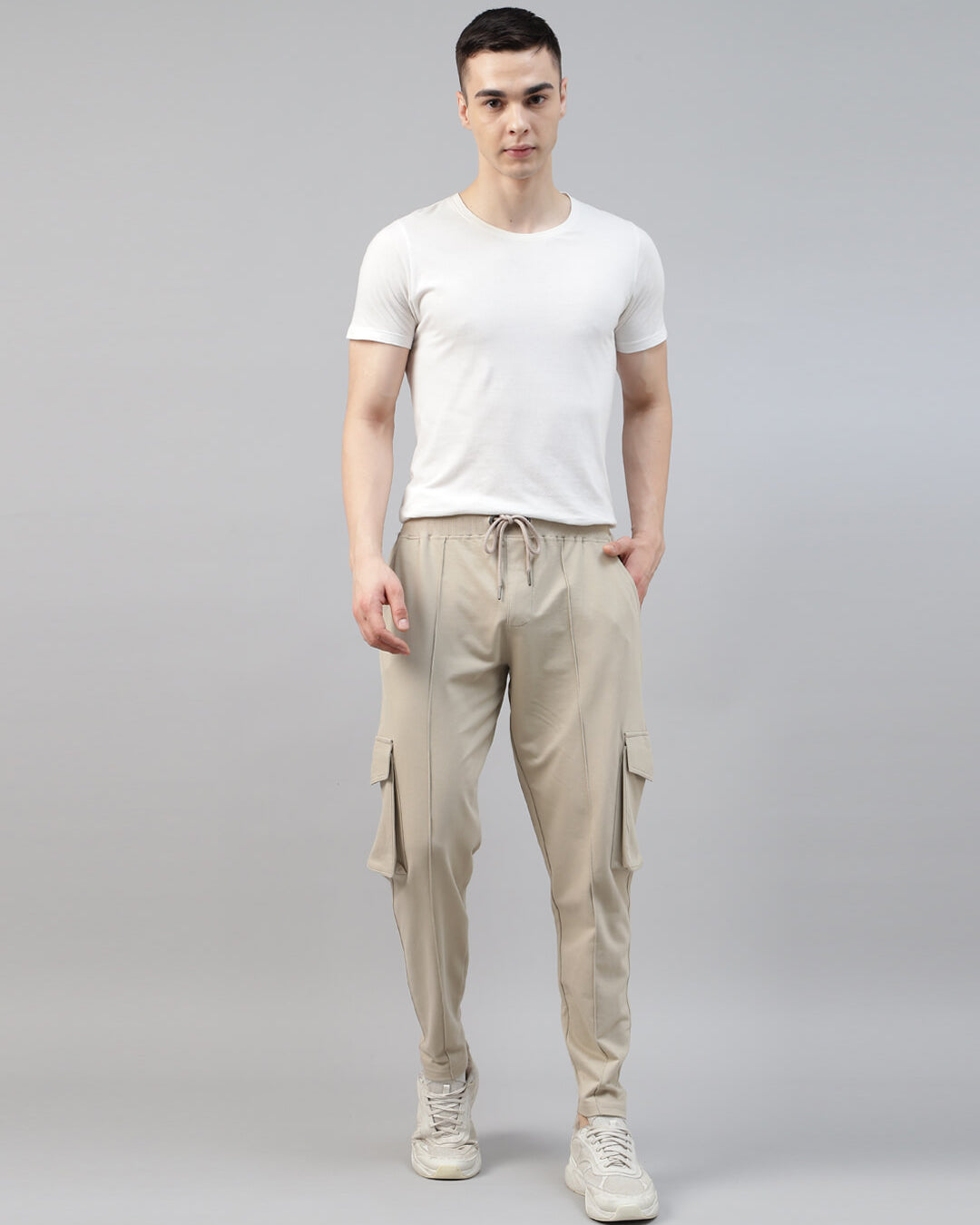 man wearing a white t shirt with beige cargo jogger pant
