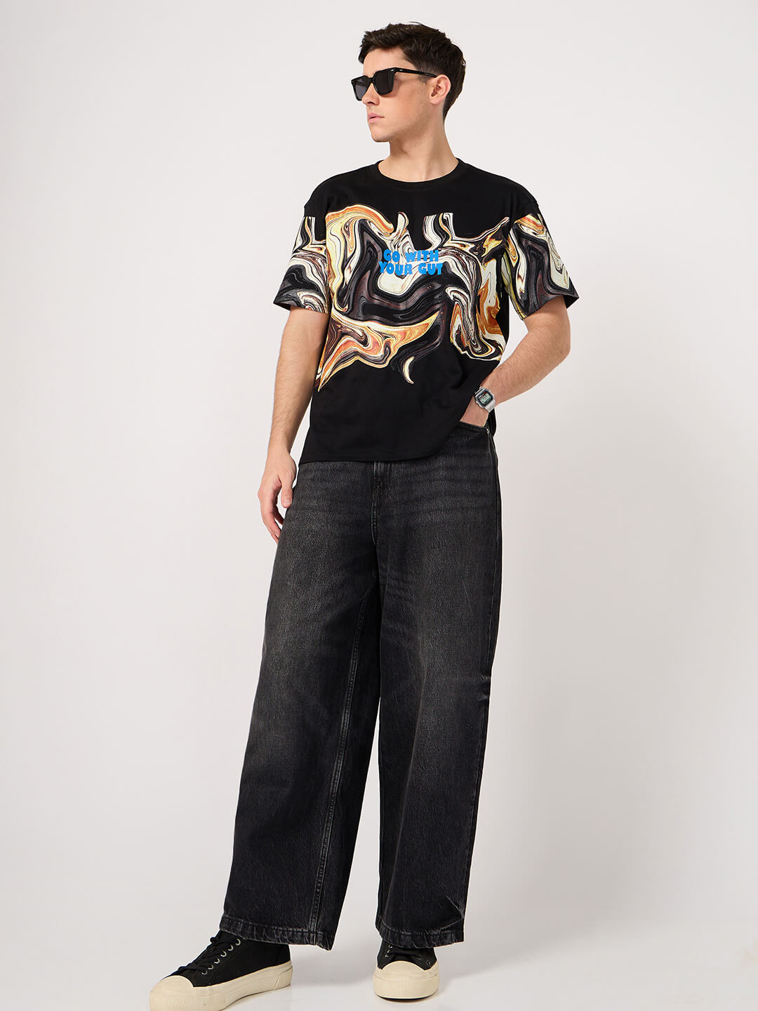 man wearing a black cotton printed tshirt and jeans