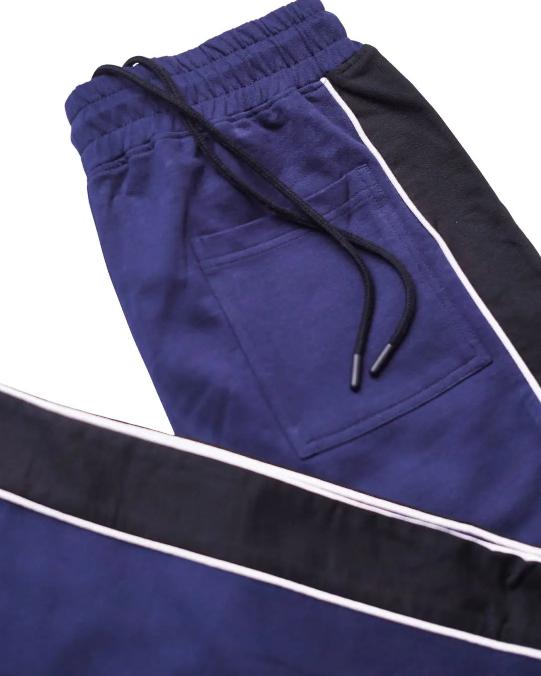 Navy blue and black track pants with white side stripes