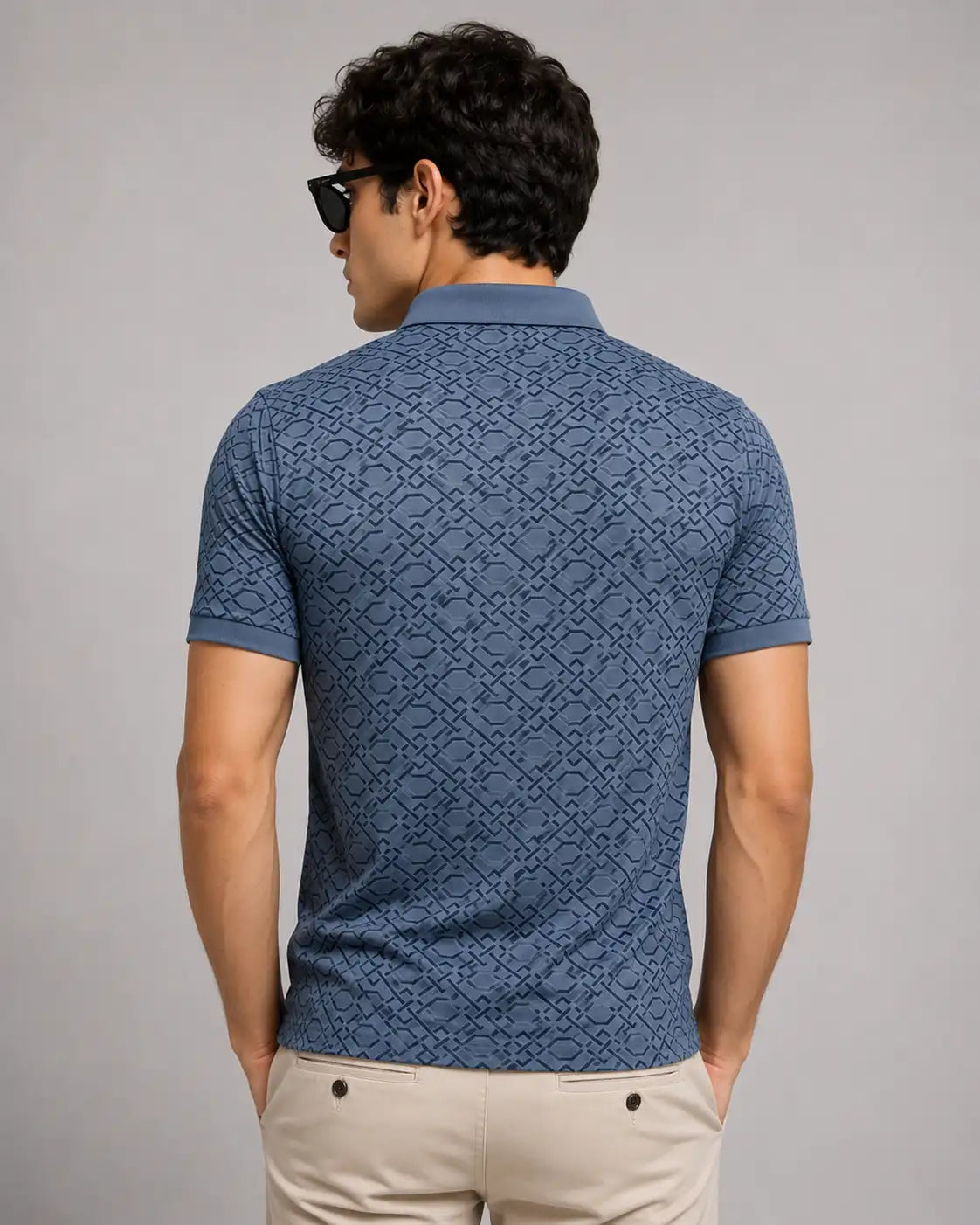 man in short-sleeve blue polo t-shirt showing back