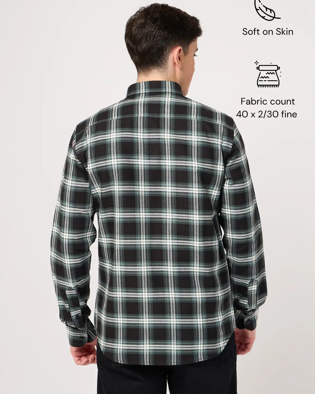Man wearing a black and green plaid shirt