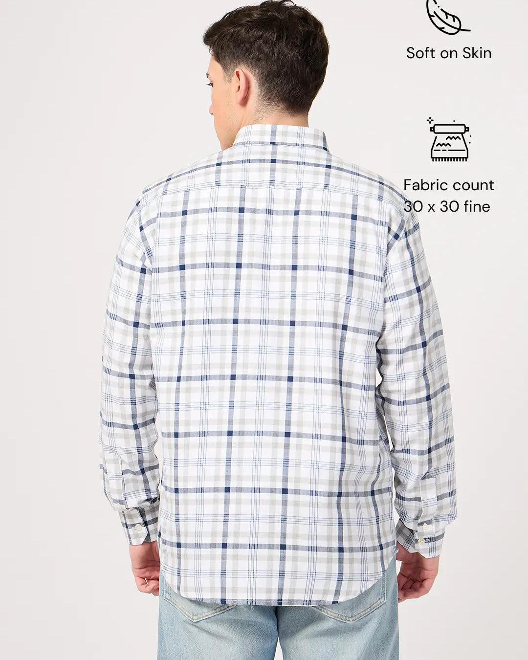 Man wearing a plaid shirt with text indicating shirt's features