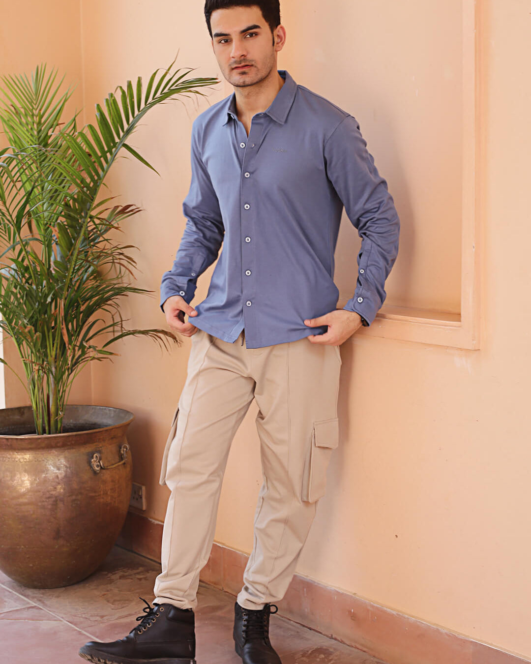 man wearing a full sleeve grey knitted shirt and beige cargo jogger