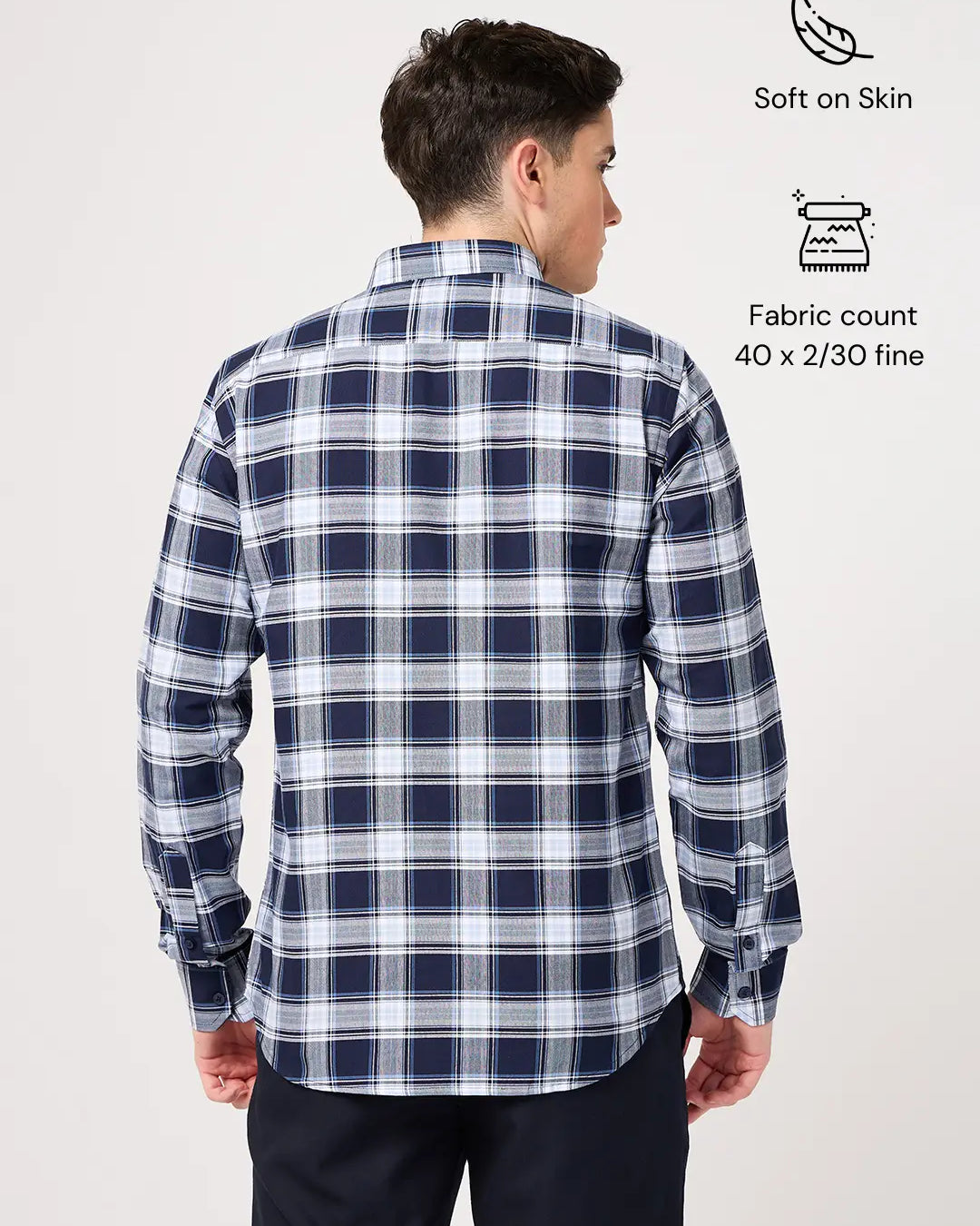 Man wearing a blue and white checkered shirt with fabric details on a white background