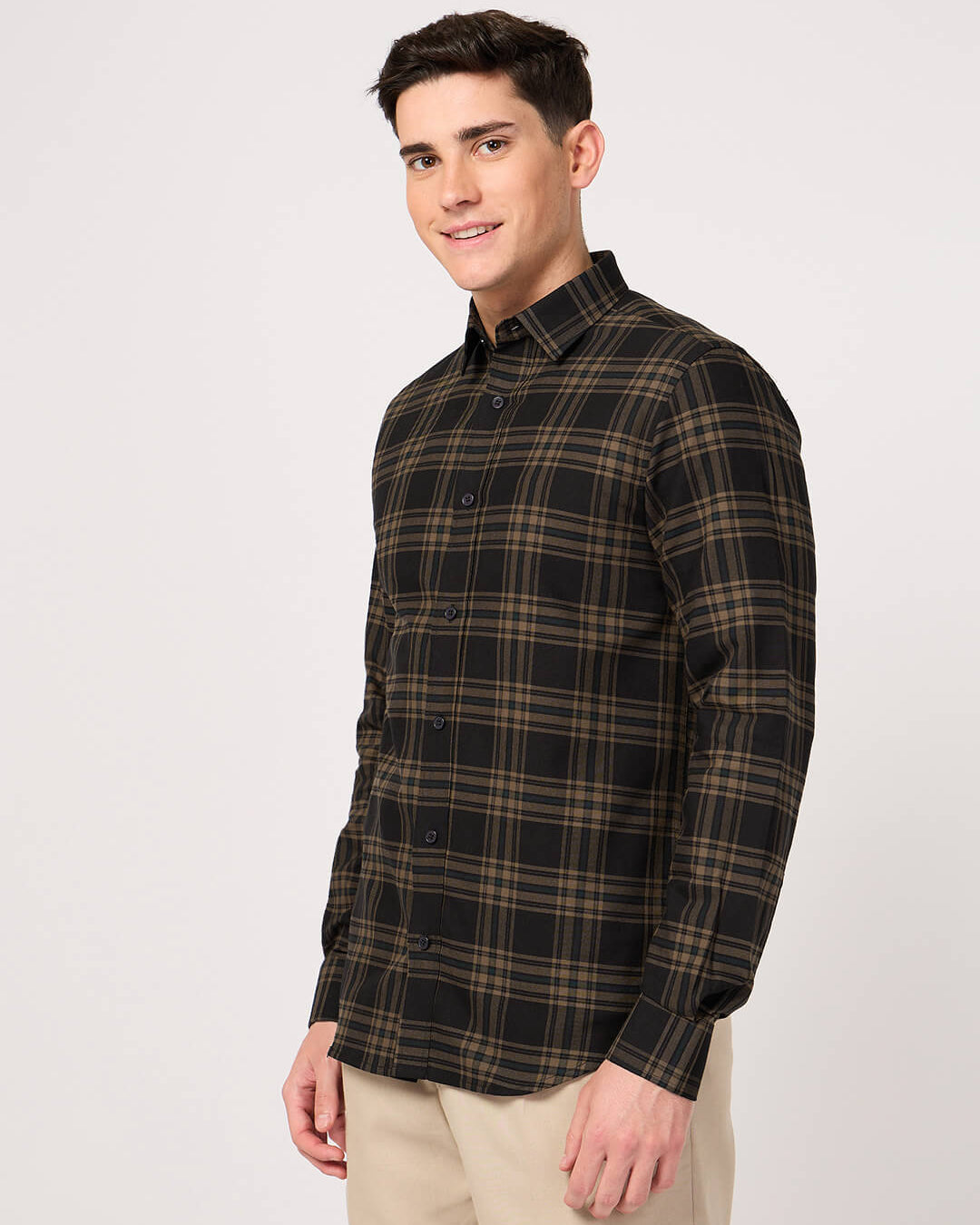 Man wearing a plaid shirt on a white background
