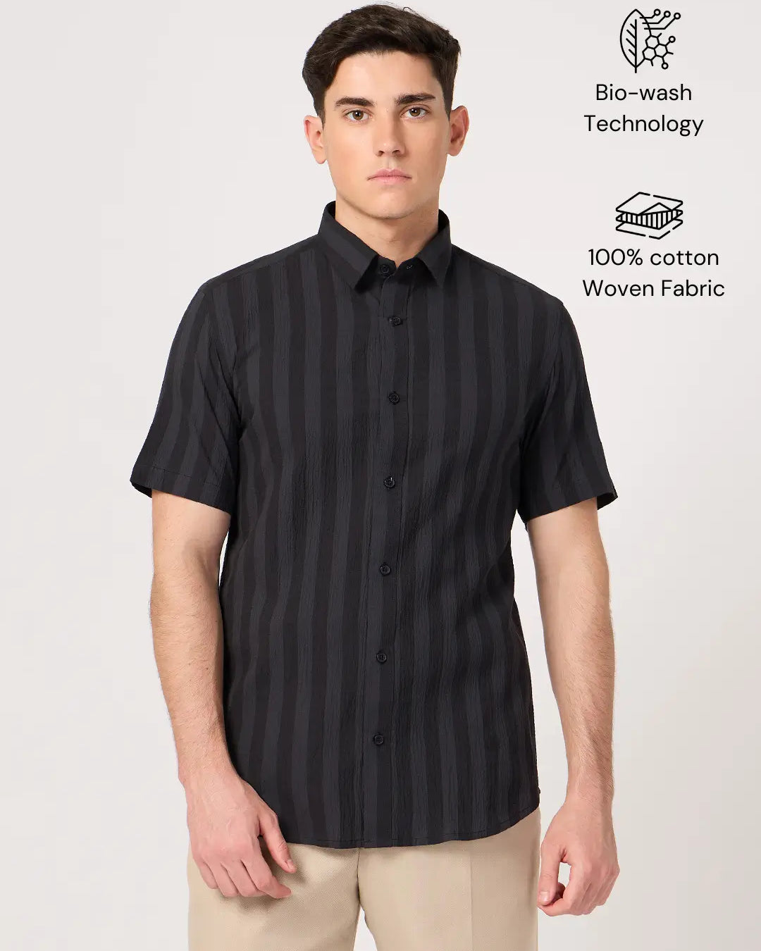 A man wearing a striped half sleeve shirt.