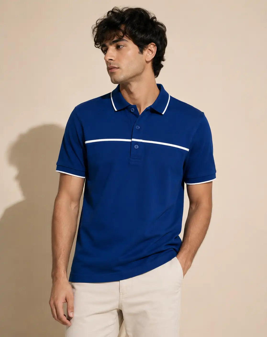 A man wearing a royal blue polo t-shirt with white strip