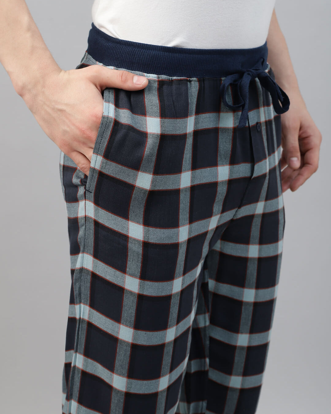 Person wearing navy and gray checkered jogger pant