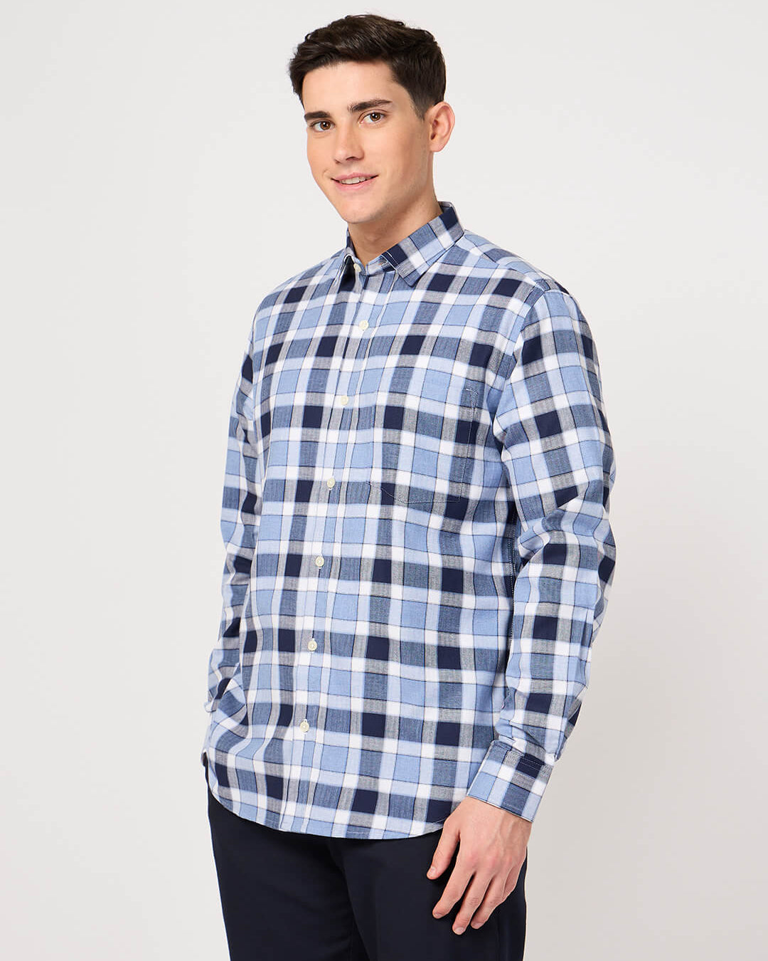 Man wearing a blue and white checkered shirt made with pure cotton