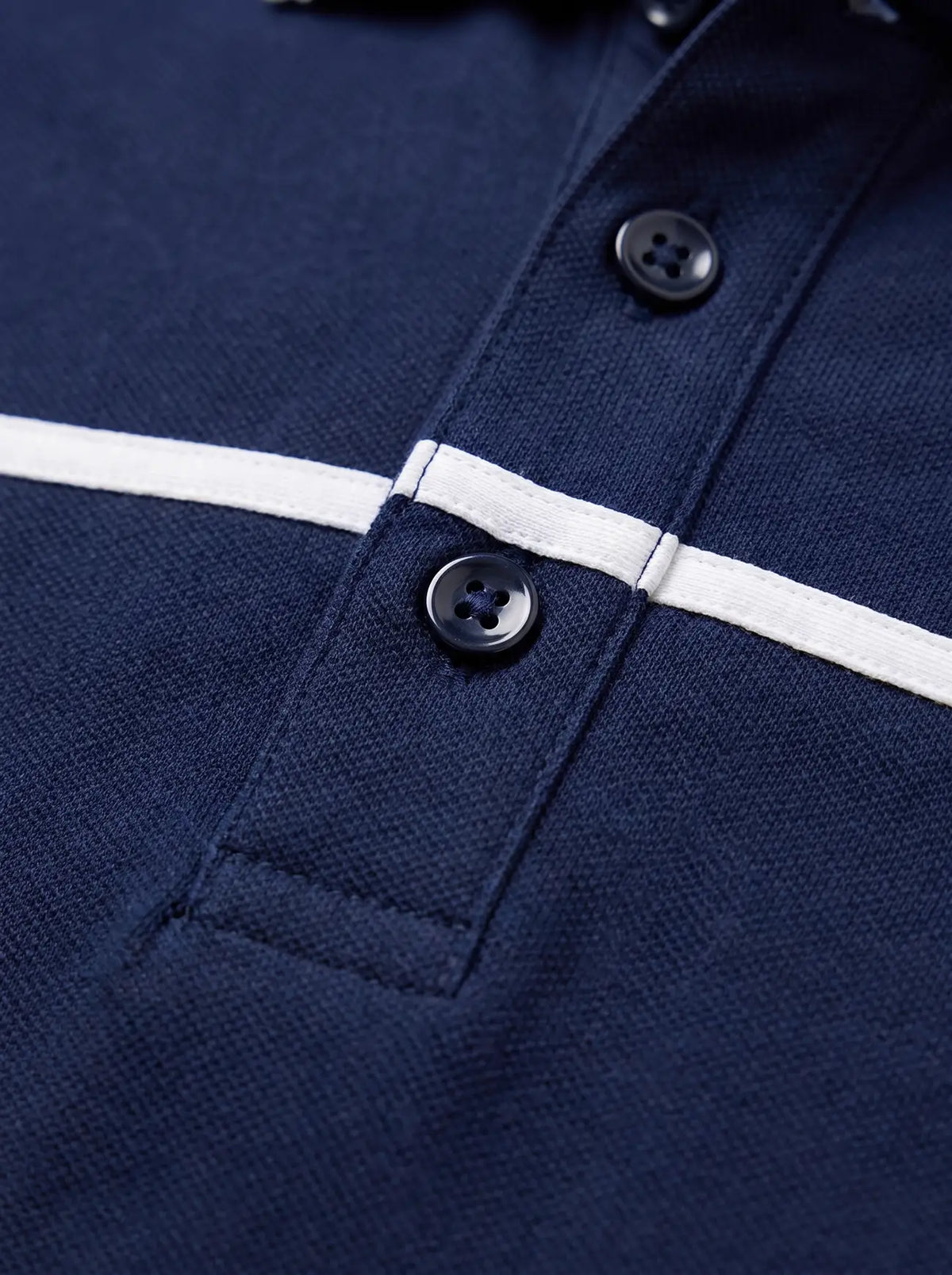 Close-up of a navy blue polo shirt with a white horizontal stripe across the chest
