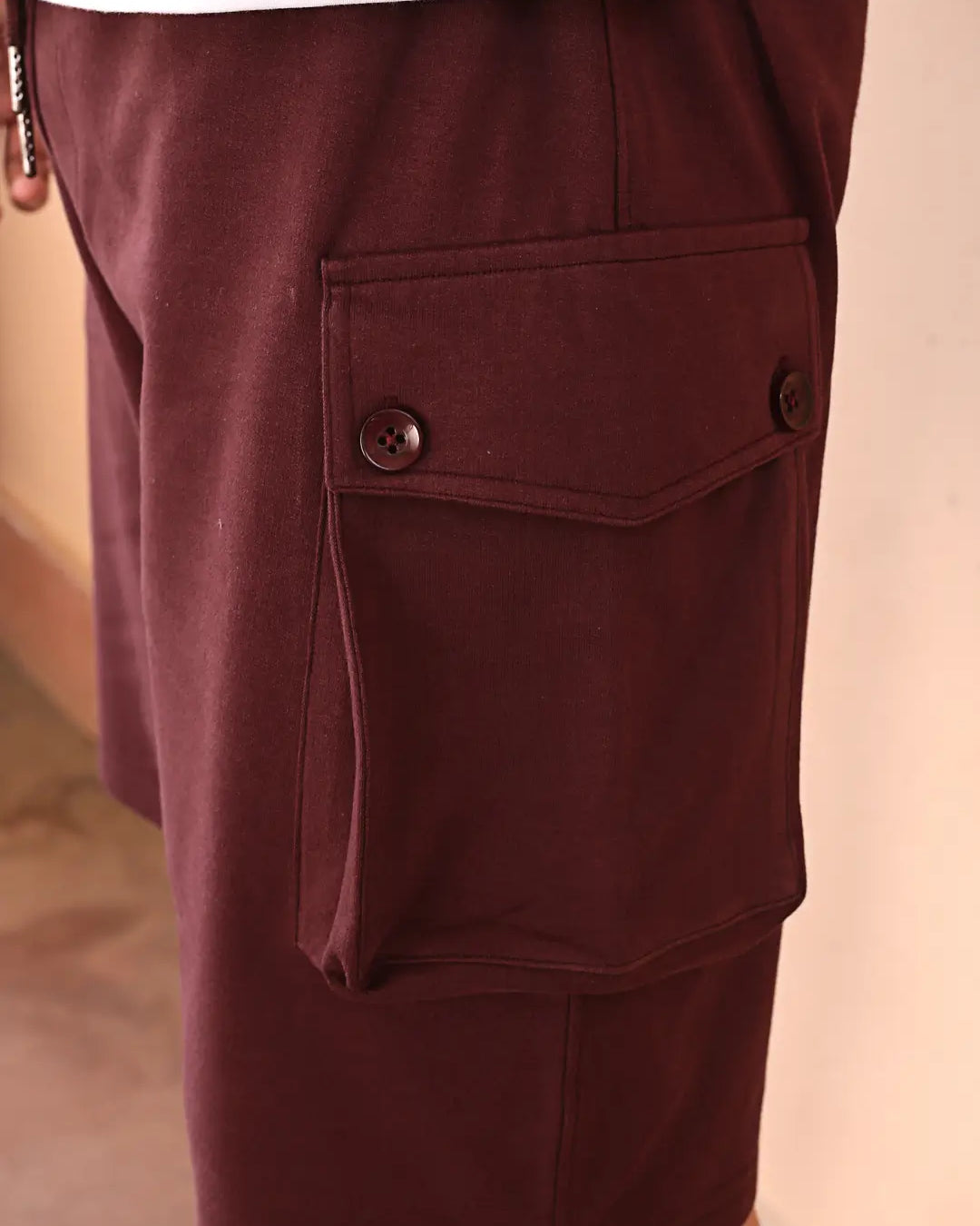 Close-up of maroon shorts with pockets