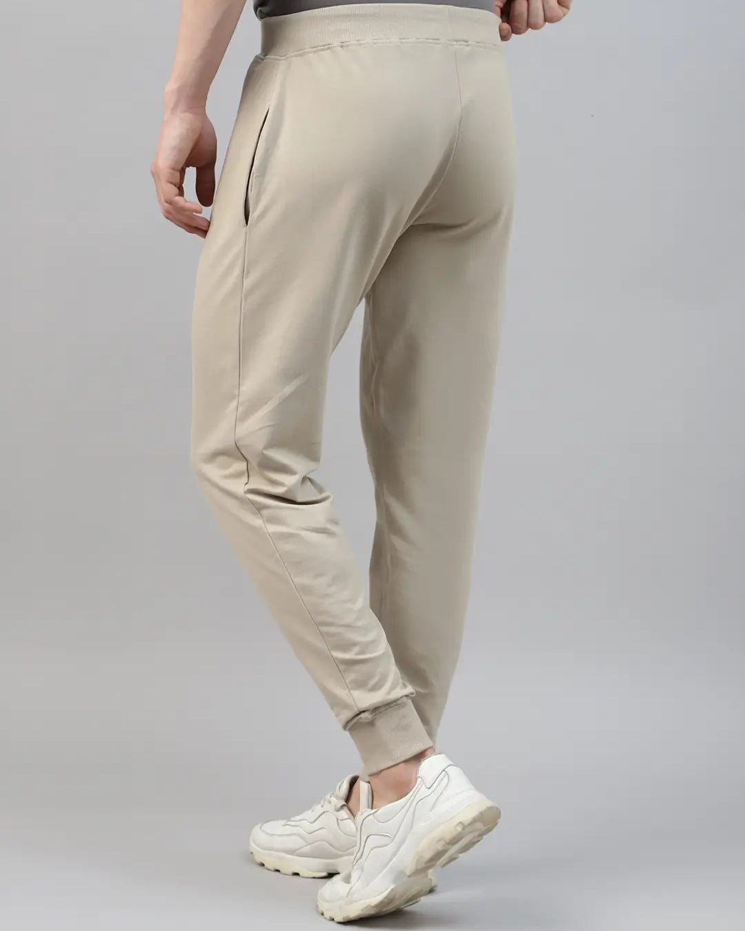 Beige rib jogger worn by a person on a gray background