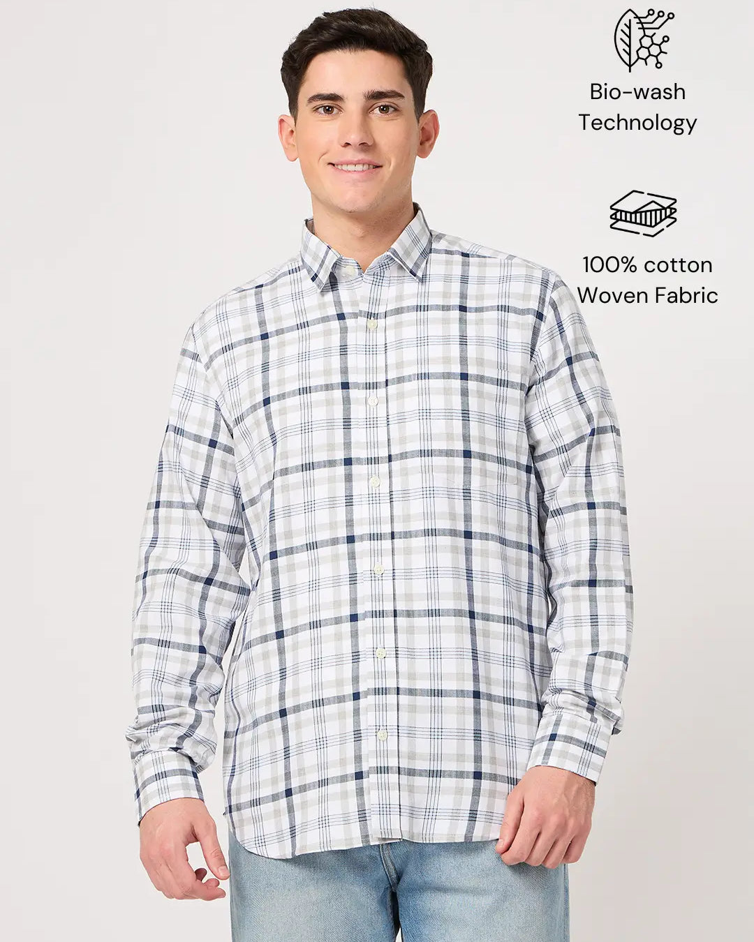 Man wearing a plaid shirt made with cotton fabric