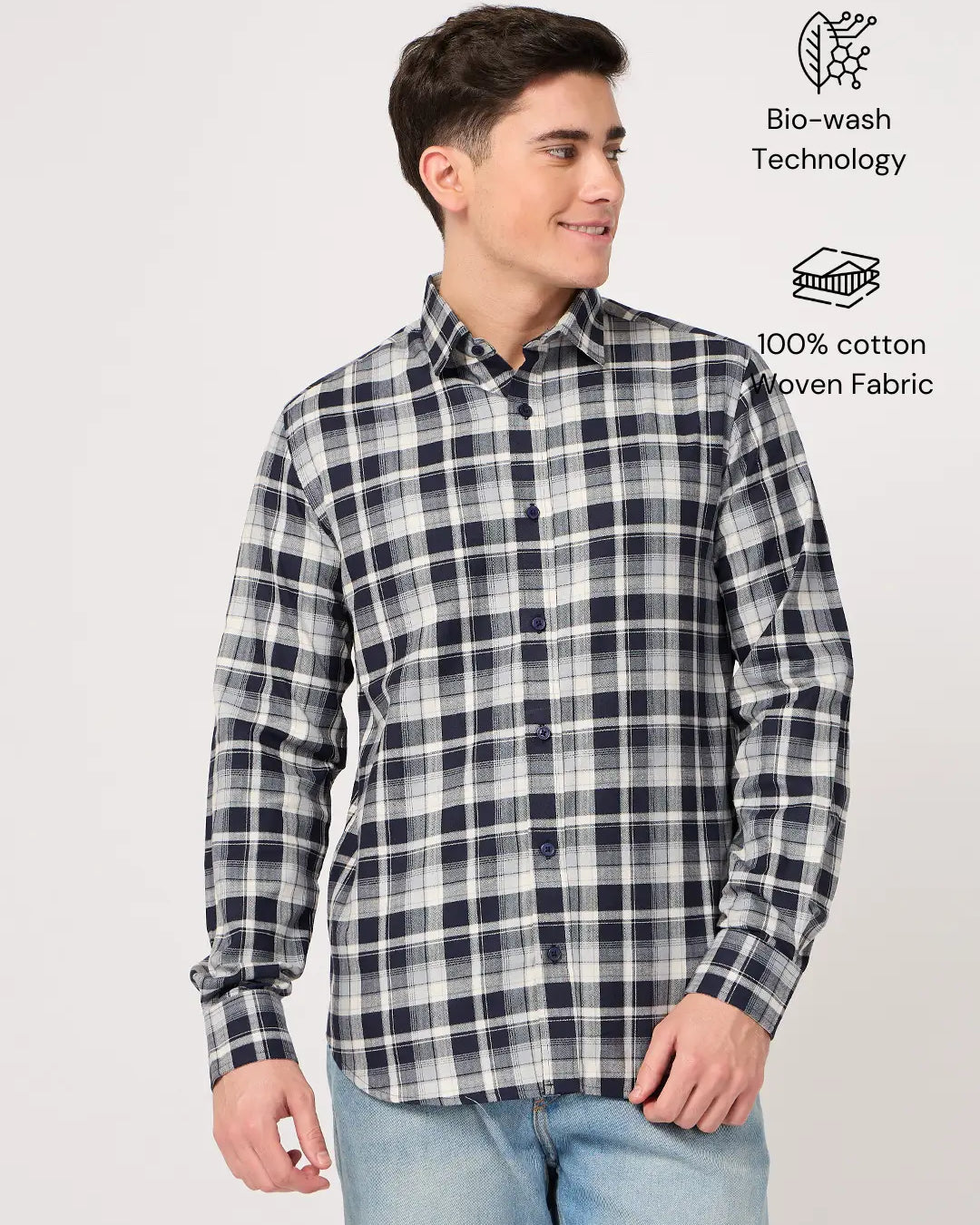 Man wearing a navy and white checkered shirt made with pure cotton fabric