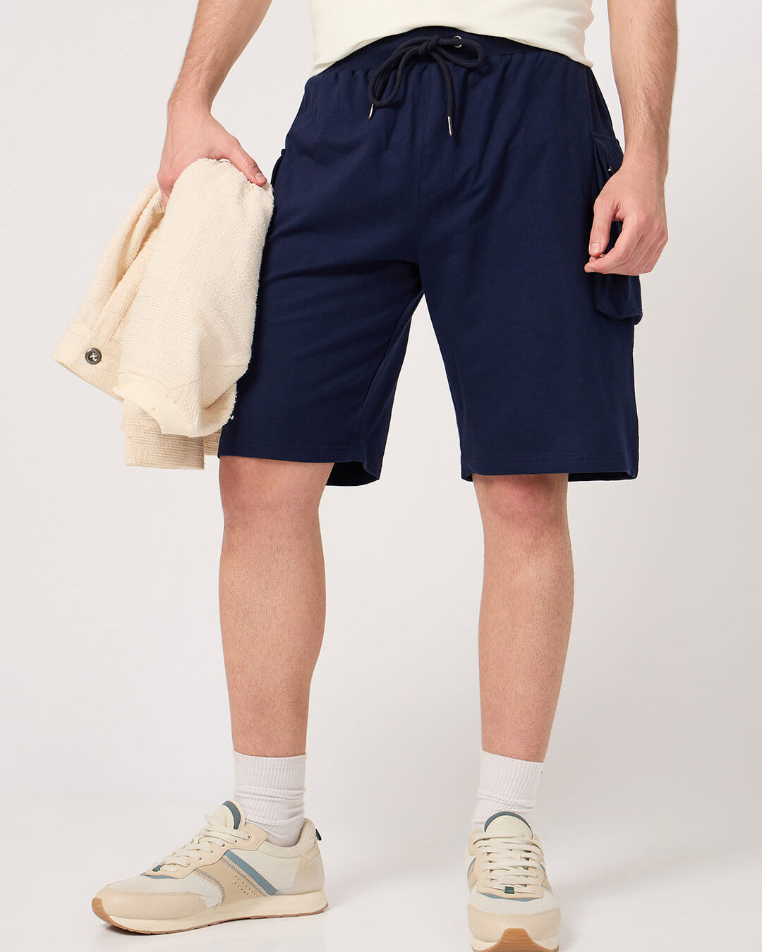 Person wearing navy cargo shorts