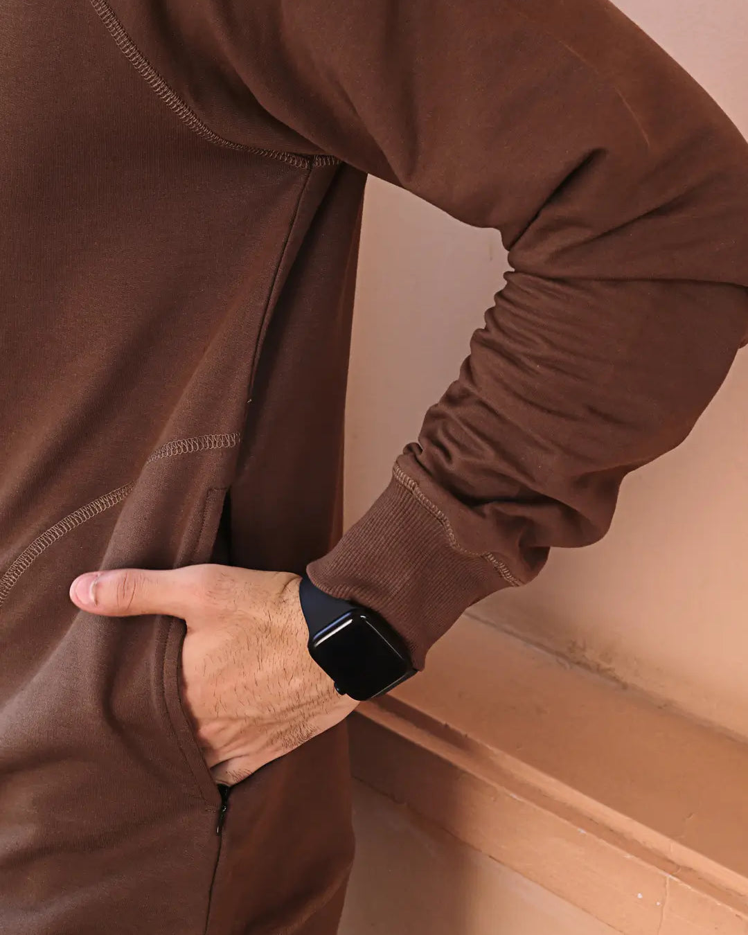Person wearing a brown long-sleeve sweatshirt