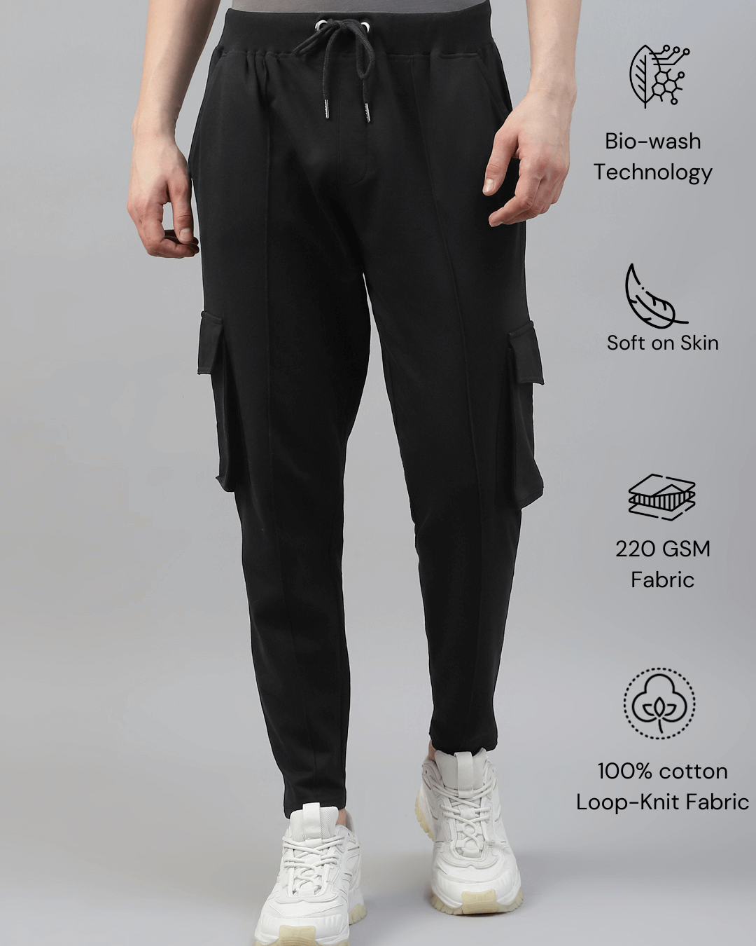 Men's cotton cargo pocket pants in black color, featuring multiple pockets and a drawstring waist.