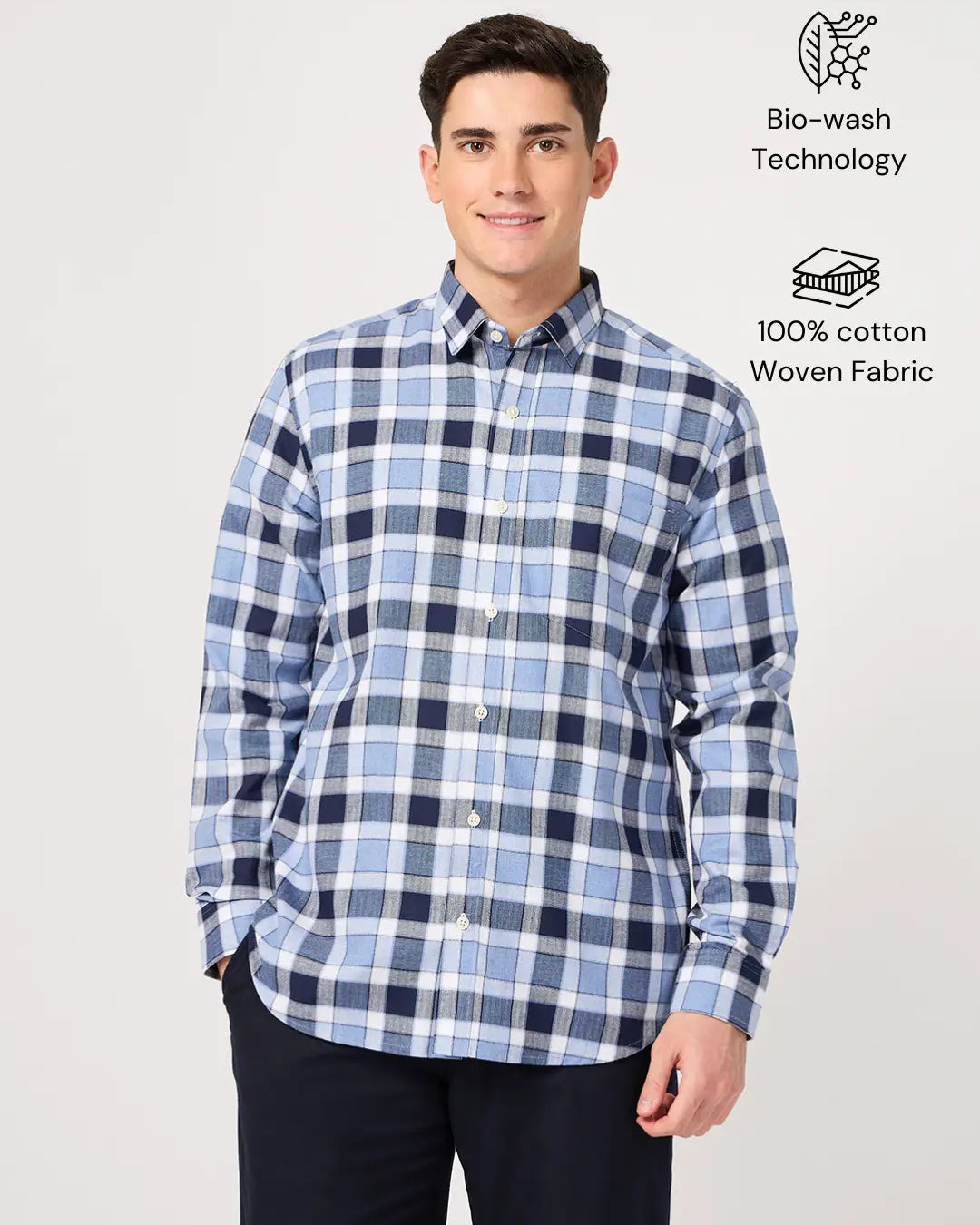 Man wearing a cotton blue check shirt with text indicating 'Bio-wash Technology' and '100% cotton Woven Fabric'.