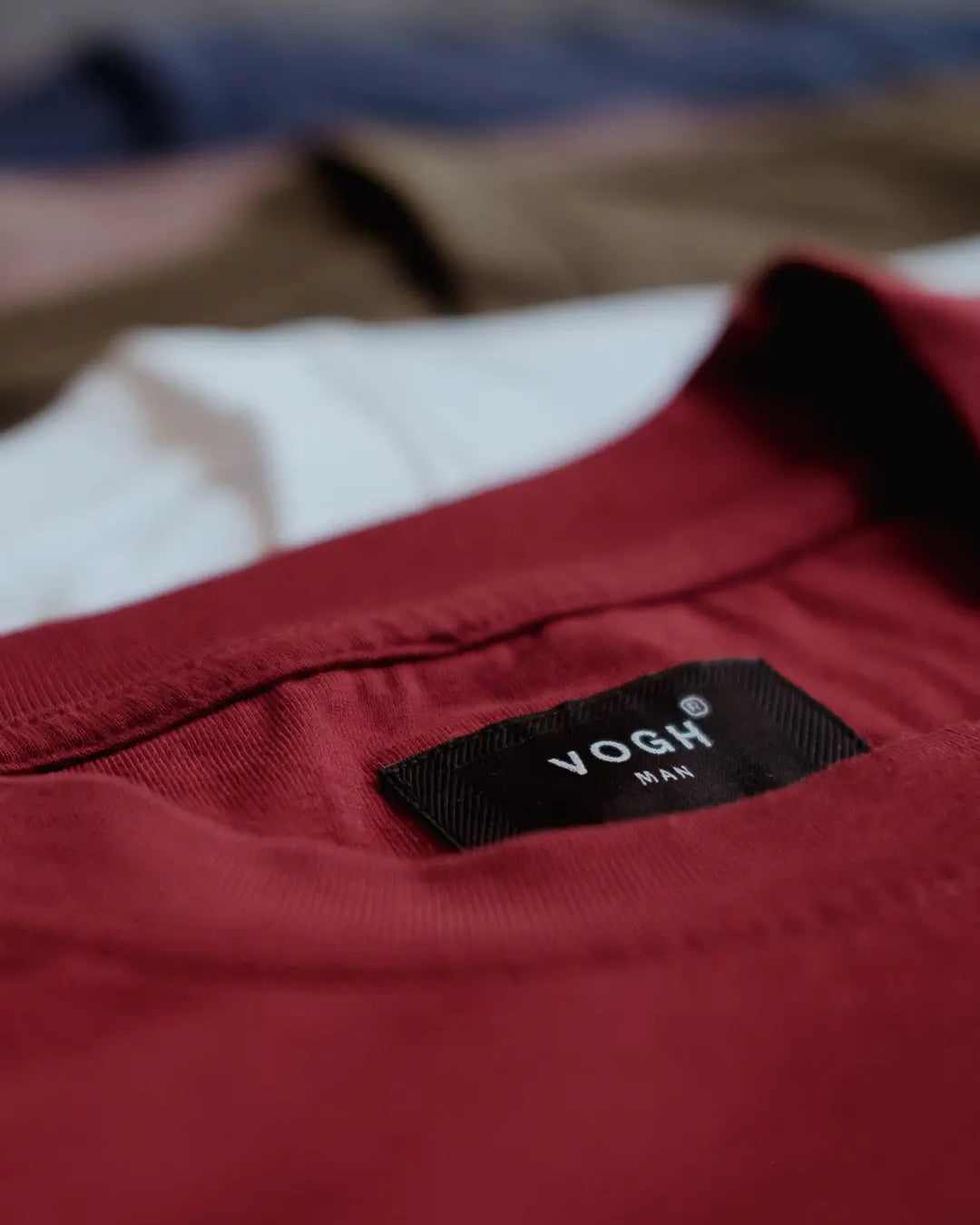 Close-up of a red round neck t shirt with a VOGH brand label