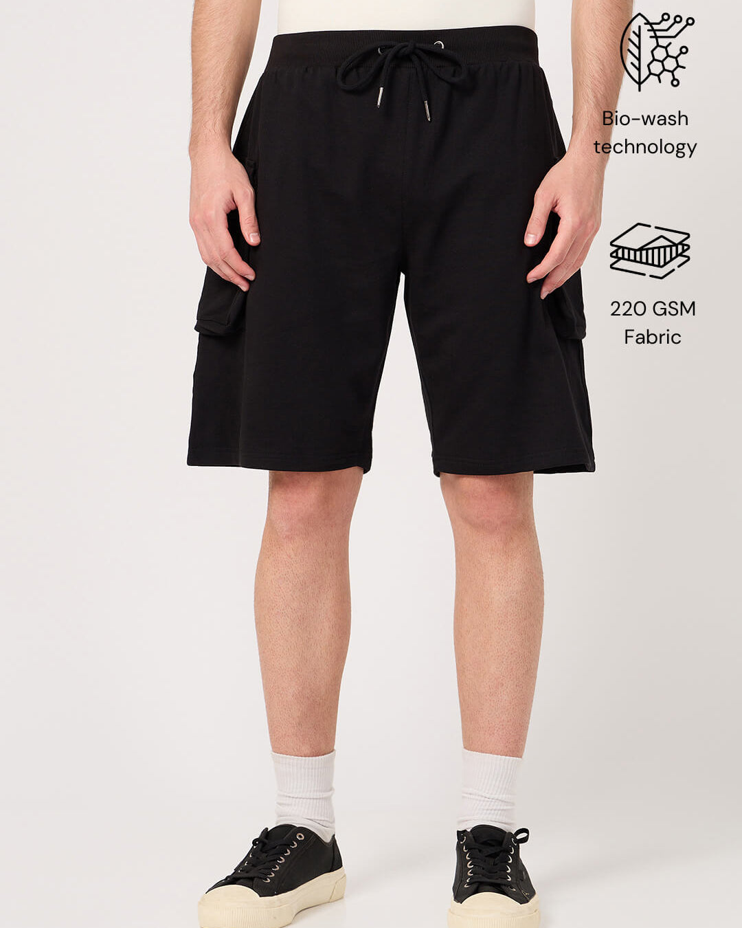 Person wearing black cotton cargo shorts