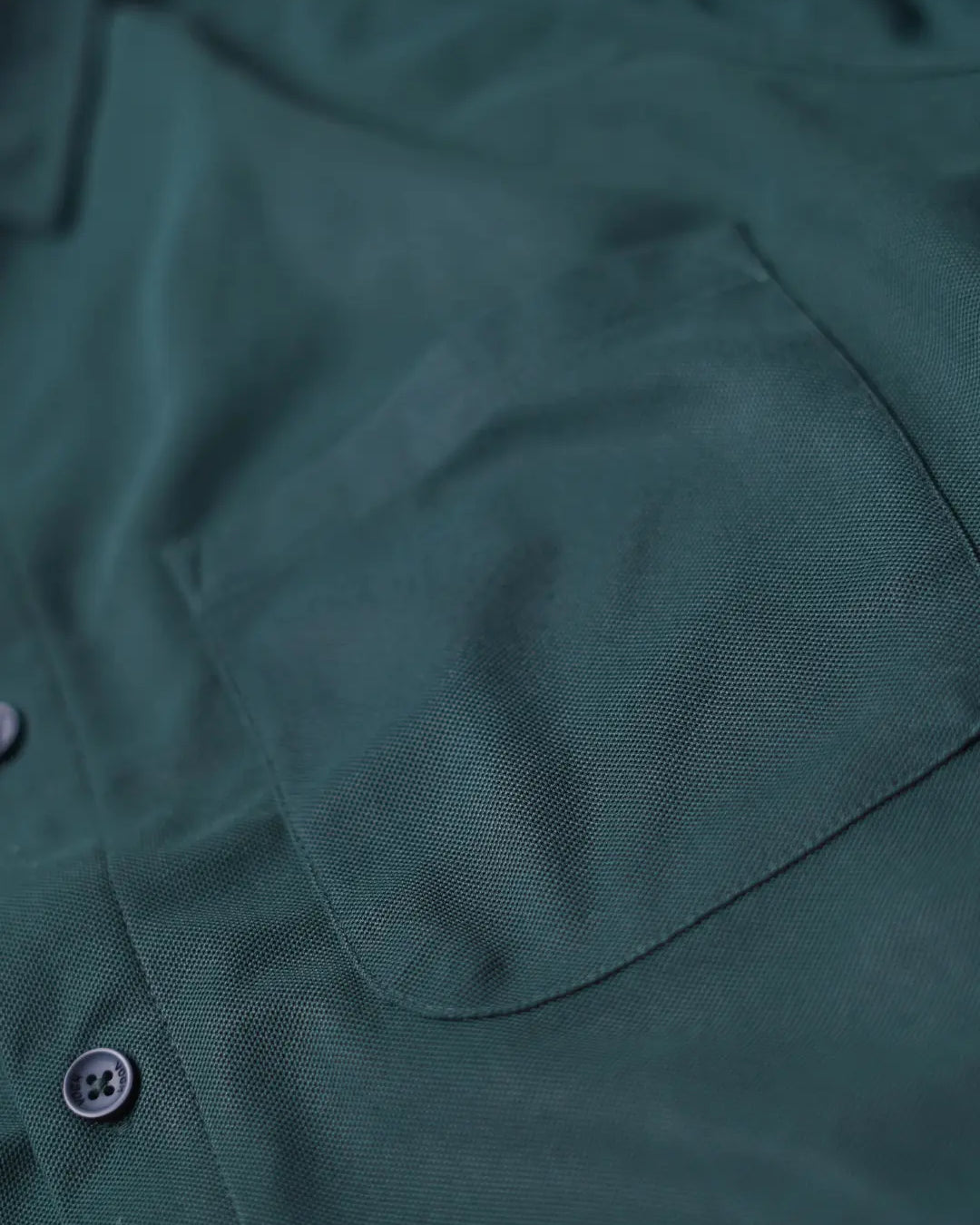 Close-up of a dark forest green shirt