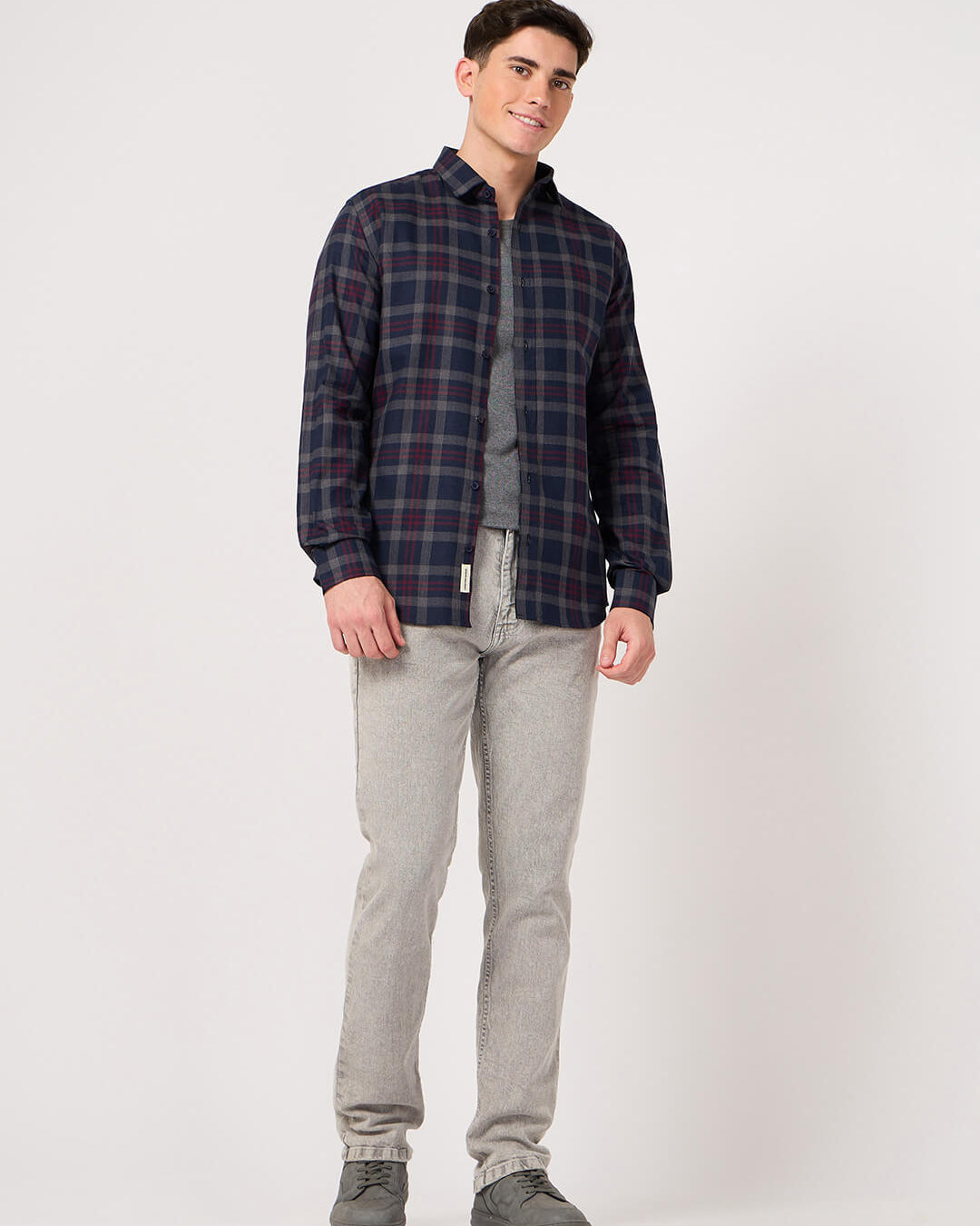 man in navy blue maroon check shirt and jeans