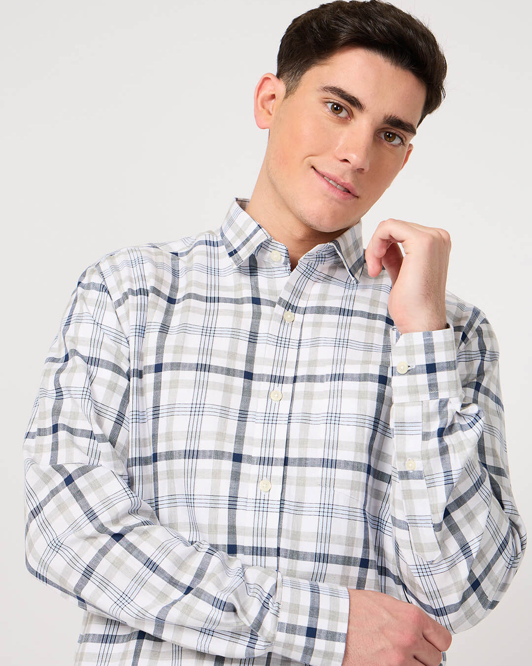 Man wearing a checkered shirt against a plain background
