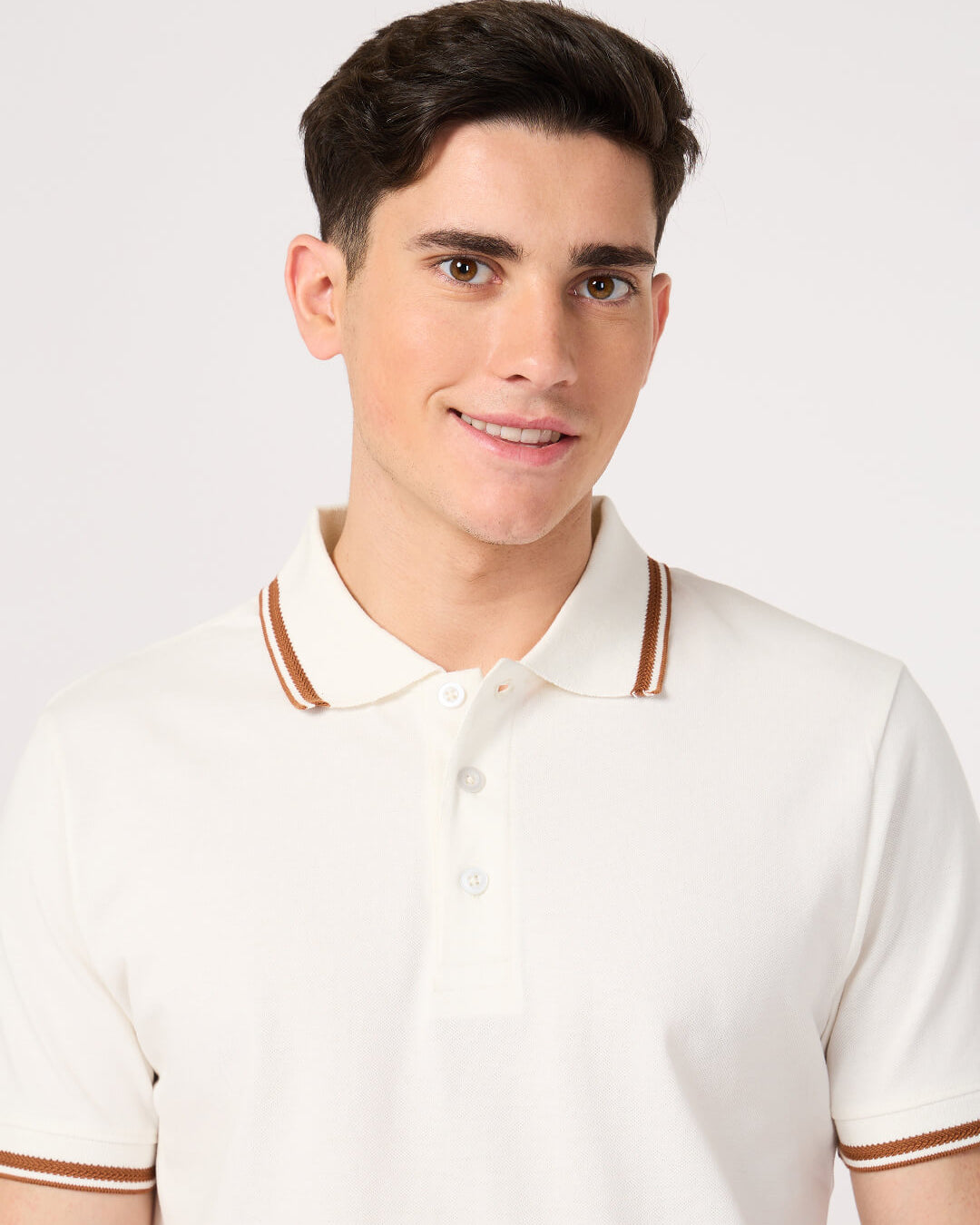 man wearing a classic white polo t-shirt with jacquard collar made with cotton pique fabric