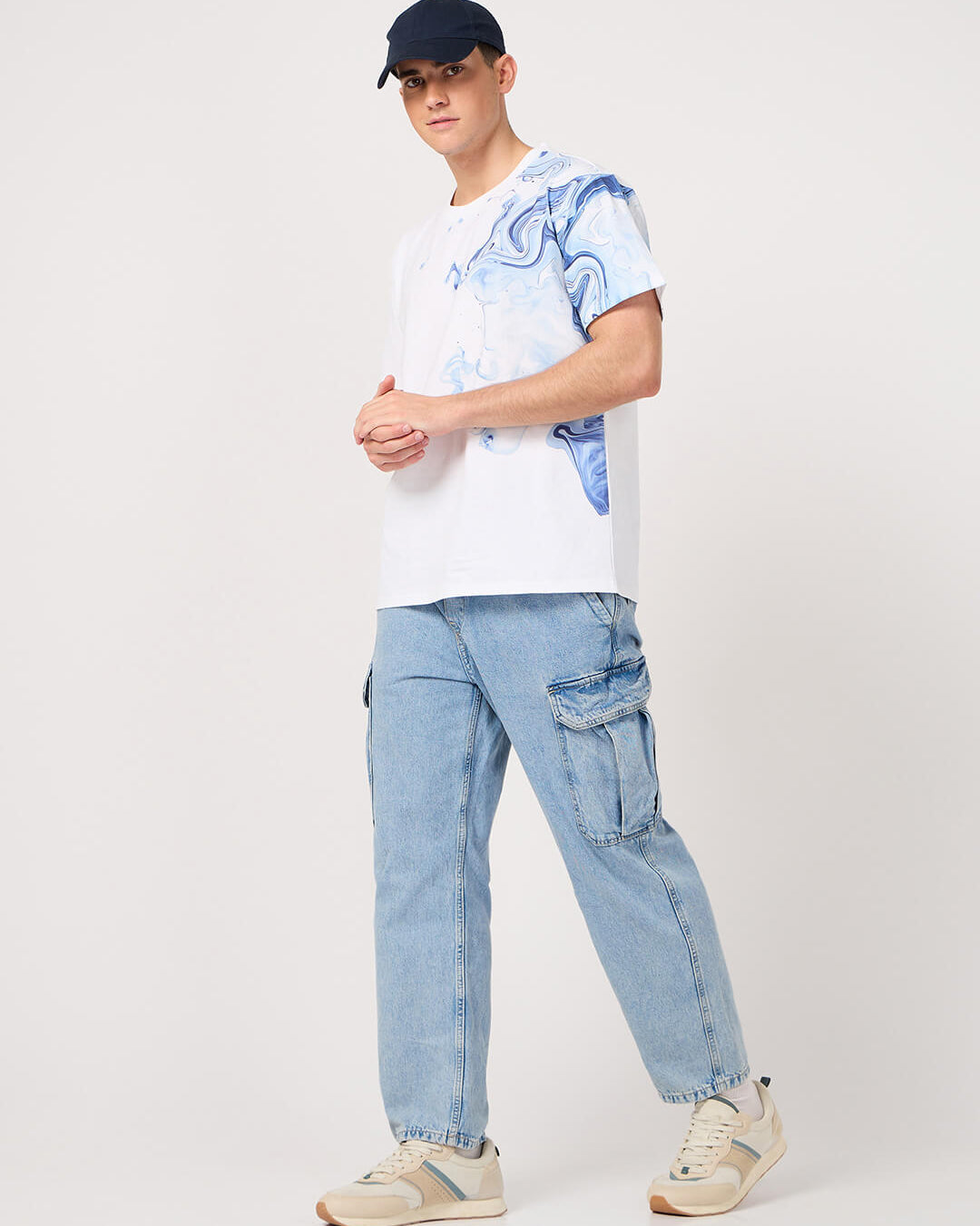 man wearing a white printed tshirt and jeans