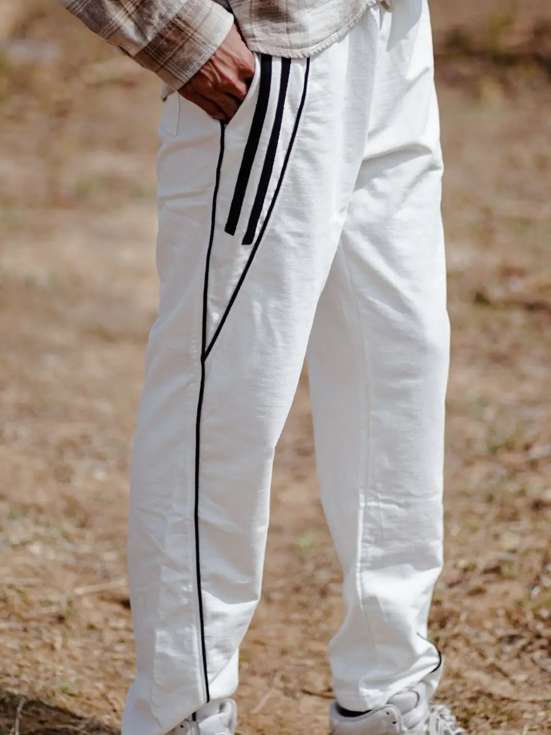 White jogger pants with black stripes