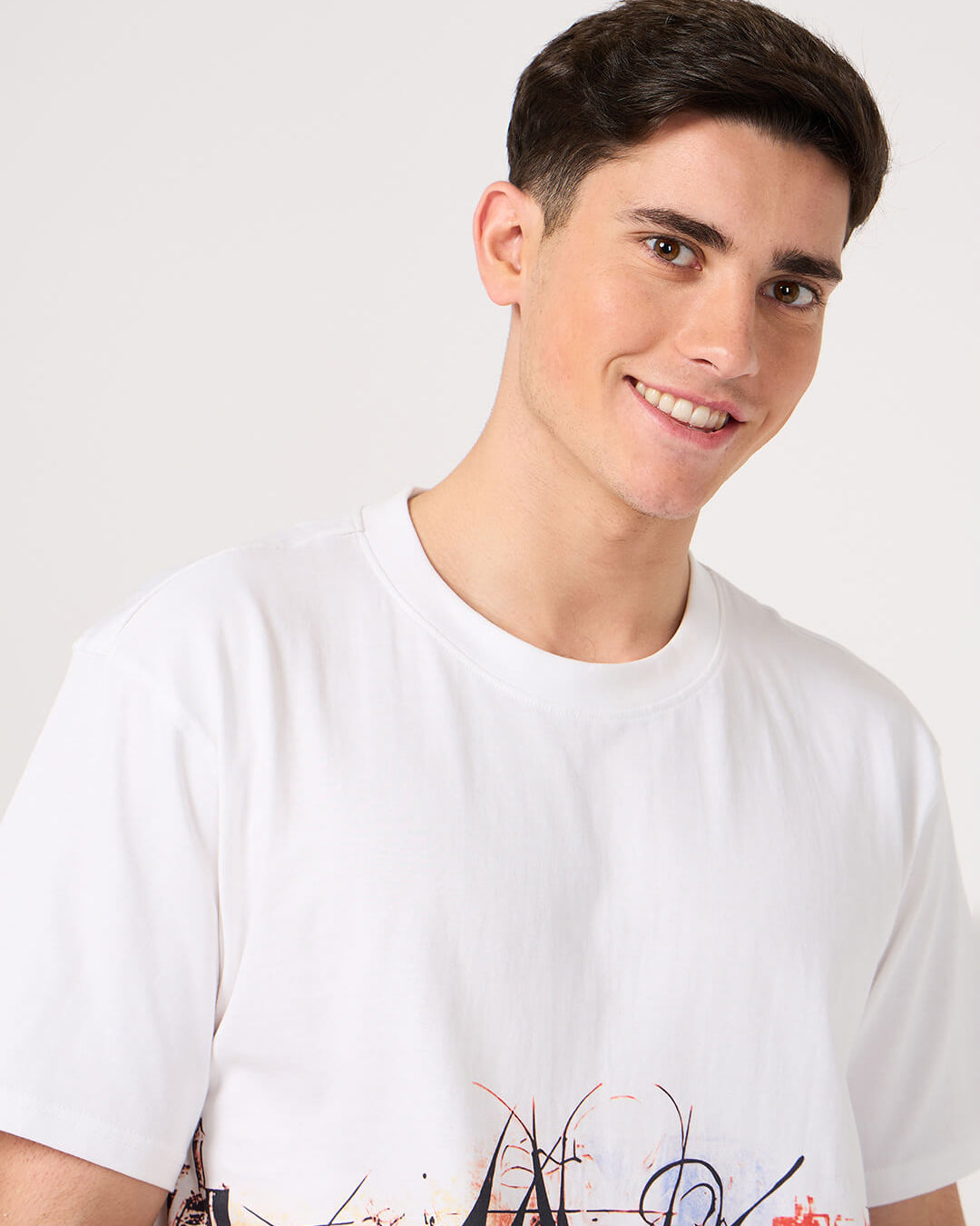 man wearing a white printed t shirt by vogh