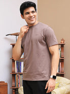 Man in brown crew neck t-shirt