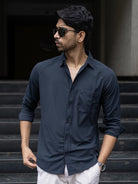 Man wearing a black blue solid shirt