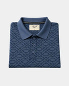 folded navy blue polo tshirt with a geometric patterned