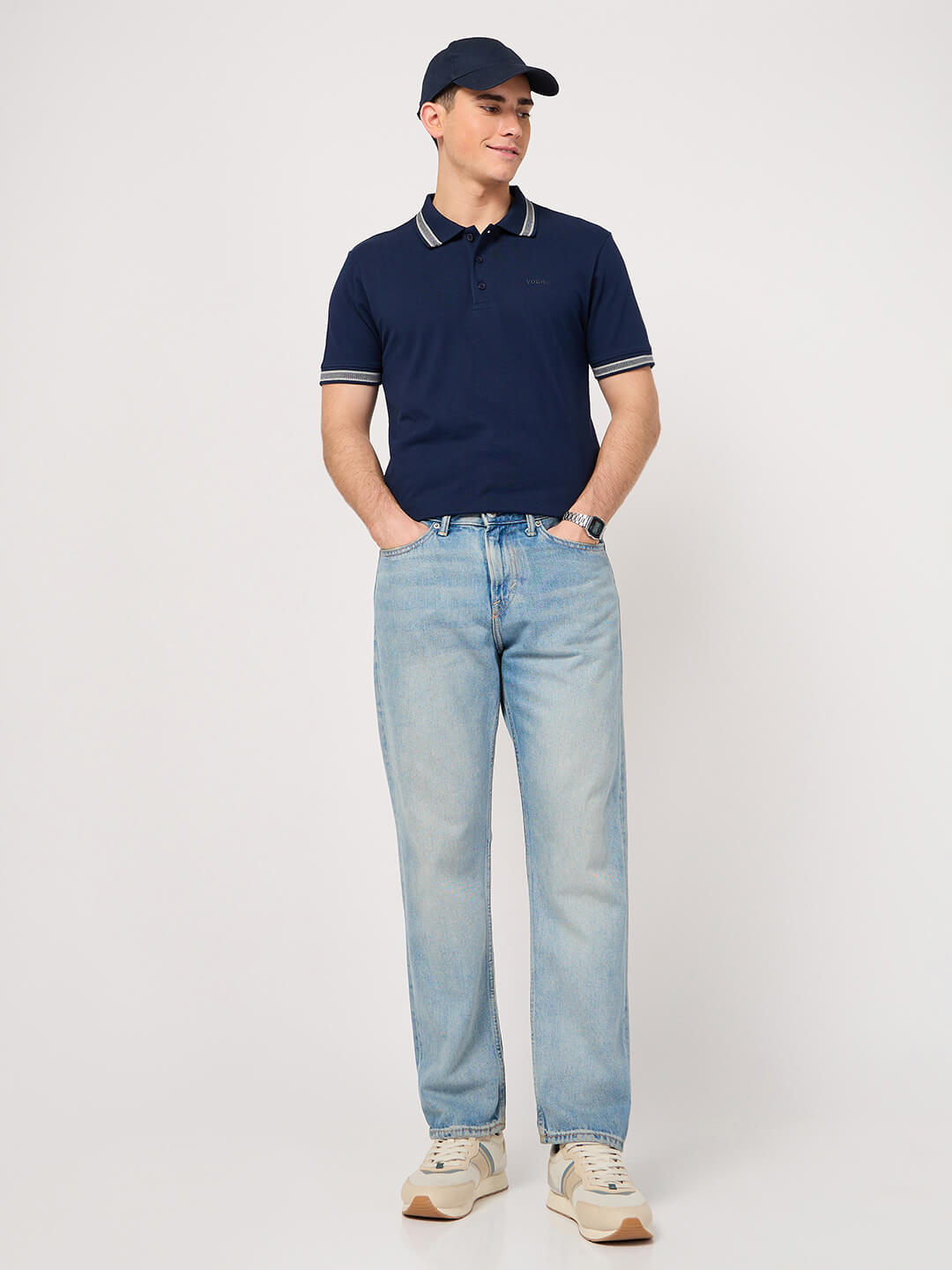 man wearing a navy blue polo shirt with jacquard collar and jeans