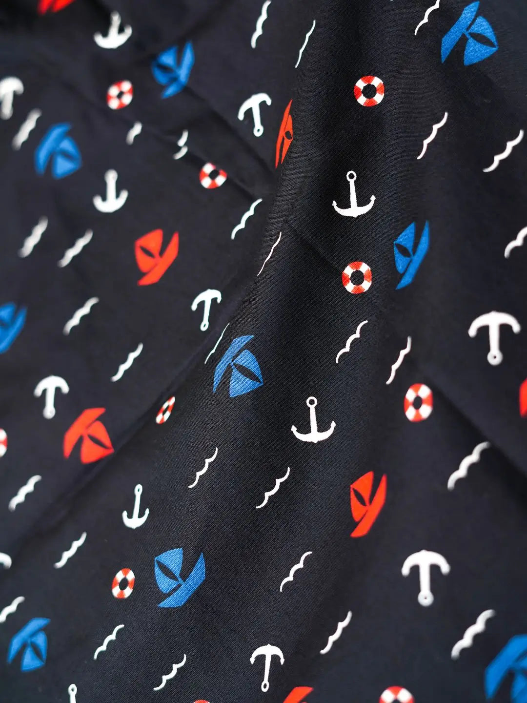 black fabric with red, white, and blue nautical pattern