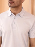 Man wearing a light sky blue polo shirt