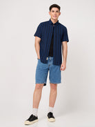 man wearing a blue half sleeve shirt with shorts