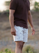 Person wearing a light grey shorts outdoors