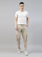 man wearing a white t shirt with beige cargo jogger pant