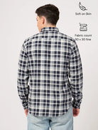 Person wearing a navy and white check shirt with text indicating features