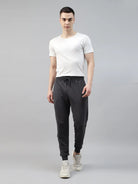 Man wearing a white t-shirt and dark gray jogger pants