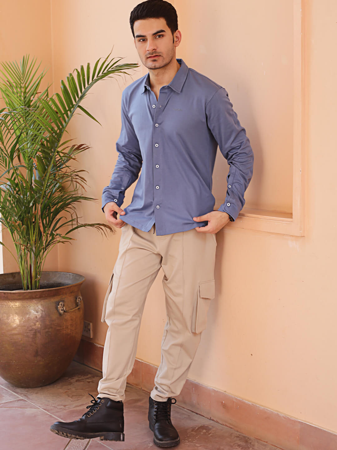 man wearing a full sleeve grey knitted shirt and beige cargo jogger